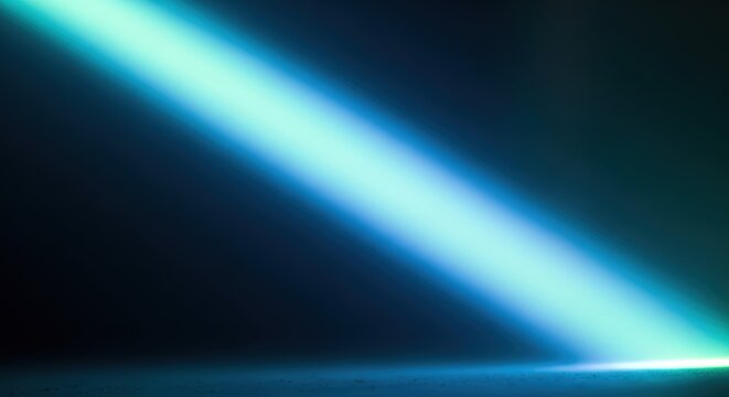 Vibrant blue-green light beam illuminating a dark, reflective surface with a dramatic diagonal glow.