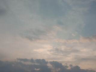 Natural texture of gray clouds in a hazy sky. Low-angle shot of the atmosphere during a cloudy sunset. © adi
