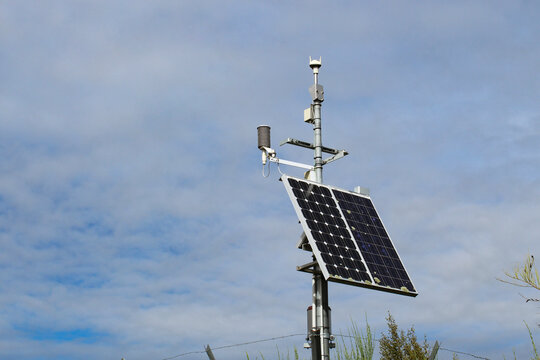 Solar-Powered Automated Weather Station and Meteorological Monitoring Equipment isolated against the Sky. Science and Technology Background.