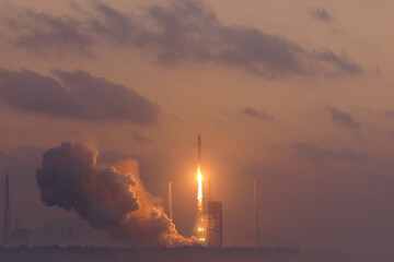 Fototapeta premium Launcher with space shuttle, aerospace program of China. Rocket launch at dawn with smoky cloud trail and soft horizon