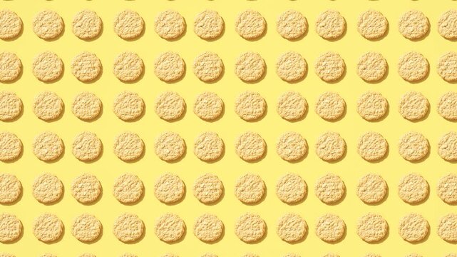 A vibrant seamless looping pattern of golden-brown cookies with texture on a sunny yellow background. Excellent for playful food themes, dessert advertisements, or cheerful culinary content in 4K.