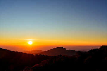Fototapeta premium Beautiful sunrise over the valleys under colorful sky in Chiang Mai, Thailand.