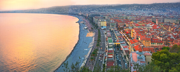 Aerial over view of coastline with Promenade des Anglais along sea in Nice at sunset. Cote d’Azur, France