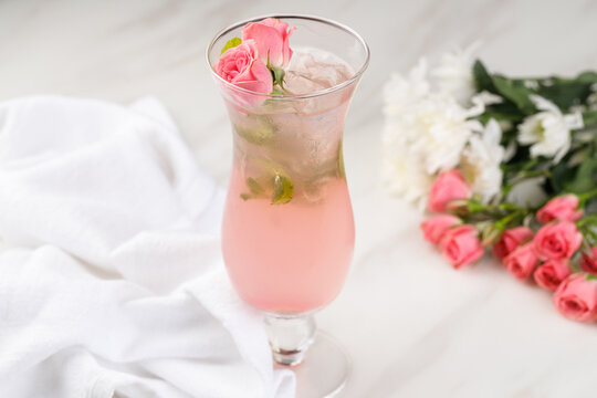 Refreshing Pink Fruit Mocktail with Floral Garnish