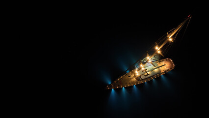 Aerial drone night shot of illuminated sail boat with wooden deck anchored in deep blue Aegan sea © aerial-drone