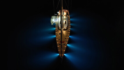 Aerial drone night shot of illuminated sail boat with wooden deck anchored in deep blue Aegan sea © aerial-drone