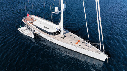 Aerial drone photo of beautiful sail boat anchored in deep blue Aegean Sea © aerial-drone