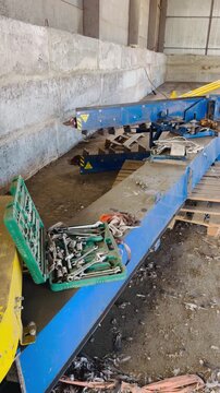A green toolbox filled with wrenches and sockets sits open next to industrial machinery in a workshop setting