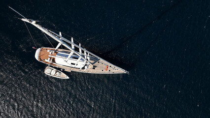 Aerial drone photo of beautiful luxury sail boat with wooden deck anchored in deep blue Mediterranean sea  © aerial-drone