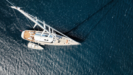Aerial drone photo of beautiful sail boat anchored in deep blue Aegean Sea © aerial-drone