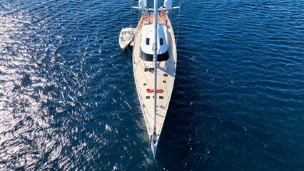Aerial drone photo of beautiful sail boat anchored in deep blue Aegean Sea © aerial-drone