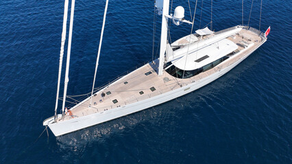 Aerial drone photo of beautiful sail boat anchored in deep blue Aegean Sea © aerial-drone