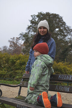 Mother and child standing together in autumn park, family connection and outdoor lifestyle concept