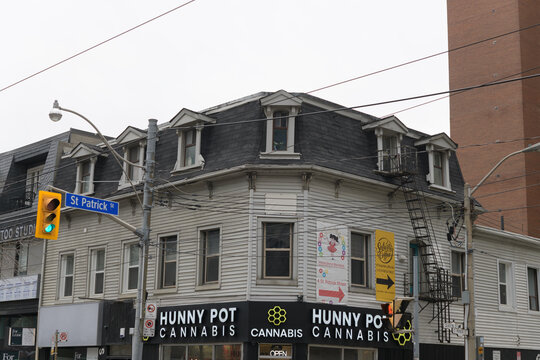 exterior of historic building and sign of Hunny Pot Cannabis located at 198 Queen St W, Toronto