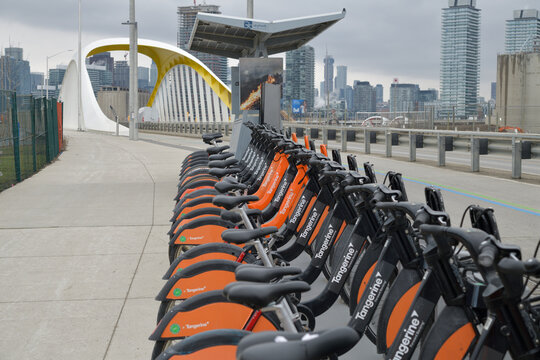 Bike Share Toronto docking station with renta vehicle with Tangerine Financial branding on Cherry St (looking north from Polson St)