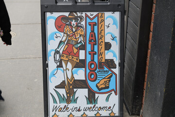 Obraz premium Tattoo & Piercing sidewalk sign on Queen St W Toronto (The Blind Tiger Tattoo, 247 Queen St W, 2nd Floor)