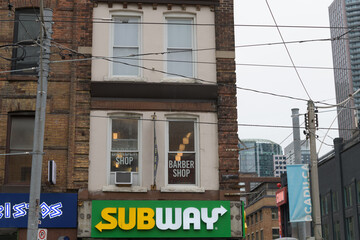 Fototapeta premium exterior building and sign of Subway, a sandwich shop chain, located here at 267 Queen St W, Toronto