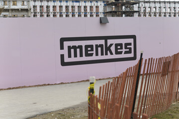 Obraz premium logo sign of Menkes Developments Ltd, a prominent private real estate developer, at 50 Queens Quay East Park, Toronto