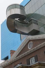 Fototapeta premium Frank Gehry's blue box contemporary expansion with exterior winding staircase over Grange House, at the Art Gallery of Ontario, Grange Park side, Toronto
