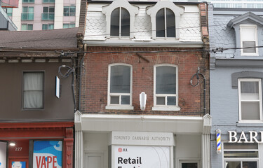 Fototapeta premium historic commercial properties and ghost sign of Toronto Cannabis Authority, 229 Queen St W