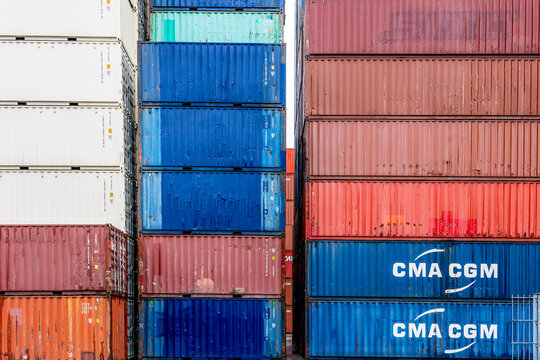 Hamburg, Germany - March 14, 2026: CMA CGM shipping containers and others stacked high at freight railway yard