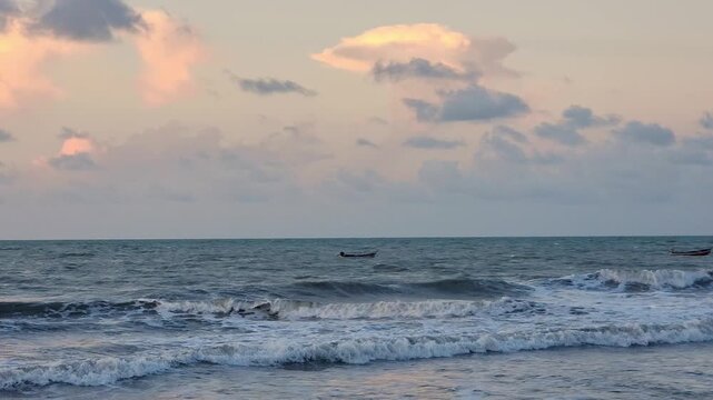 Fishing Boats on Rough Sea with Dramatic Pastel Sunset Sky and Breaking Waves at Praia do Prea, Cear&aacute;, Brazil. Northeast Brazilian Coastline
