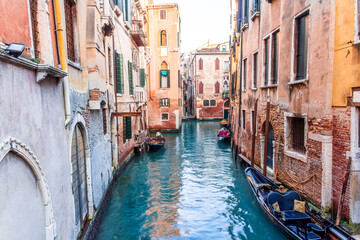 romantic view of a canal in Venice with boats and blue water and beautiful vintage buildings around the cityscape © Yaroslav