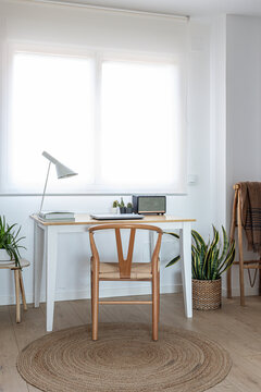 Minimalist home office with a wishbone chair setup