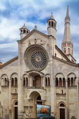Fototapeta premium Faсade of Modena Cathedral in historic center of Modena, Italy. Romanesque architecture and sunny sky style