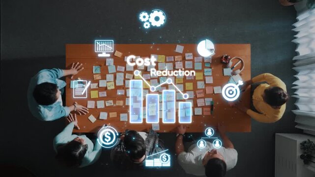 A diverse group of professionals collaborates around a wooden desk covered in sticky notes while digital icons depict cost reduction concepts, enhancing creative discussion. Raster