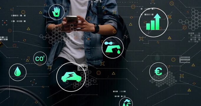 Man tapping phone by dark wall, calling up CO2, car, chart icons clustering and monitoring tech