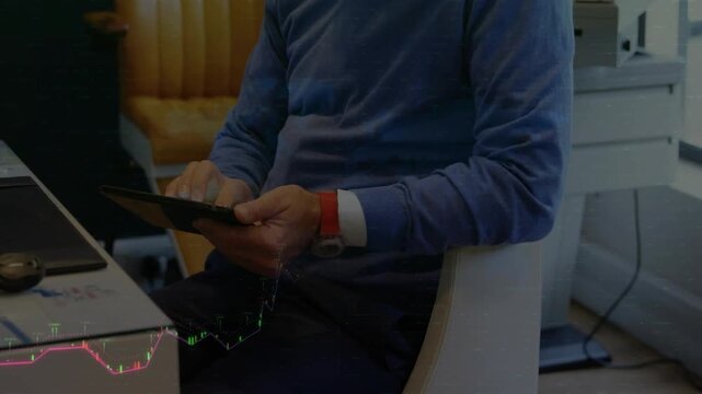 Man tapping tablet in office, causing animated financial charts covering hands while analyzing data