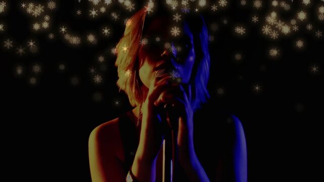 Teenage singer bringing mic closer while singing, two-tone lights, flake bokeh hovering above head