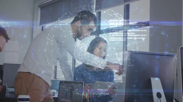 Standing man leaning pointing at tablet woman tapping as globe overlay linking screens for business