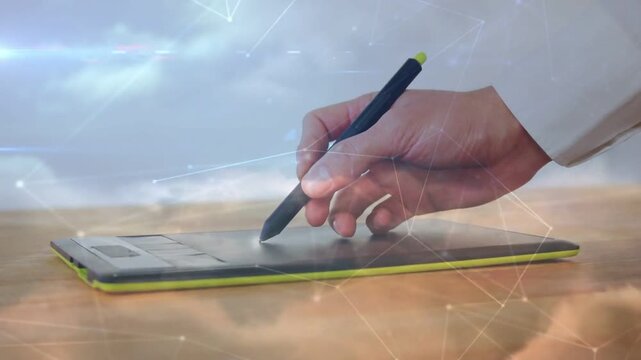 Right hand hovering, lowering stylus on tablet and drawing network overlay for design