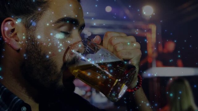 Vertical video: Thirst driving man lifting beer mug and drinking at dim bar, red beads, copy space