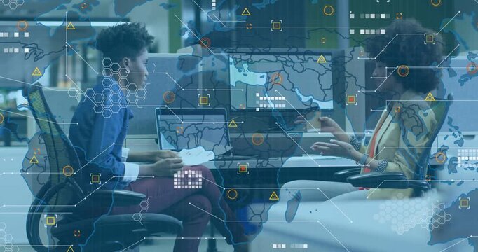 Two female coworkers at desk tapping phone, reading pages, initiating map overlays for business