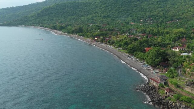 Aerial view flying along amed coastline in bali indonesia