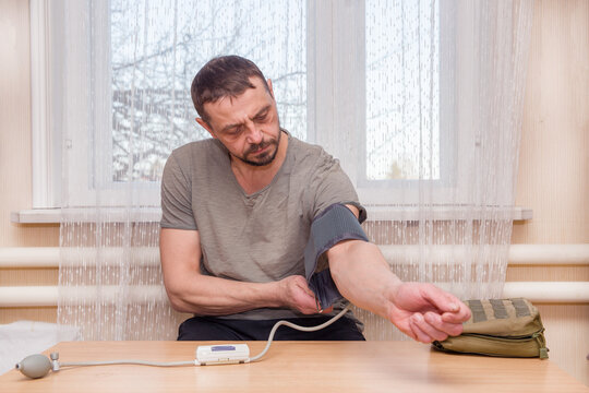 A man measures his blood pressure
