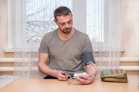 A man measures his blood pressure