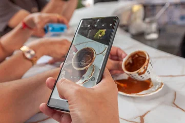 Smartphone capturing coffee cup for coffee grounds interpretation © connieguanzi.ph