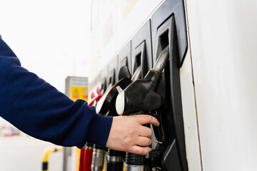 Driver refueling car using gasoline pump nozzle close-up. © Rabizo Anatolii