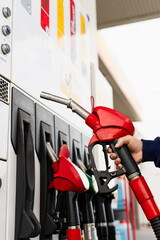 Driver refueling car using gasoline pump. © Rabizo Anatolii