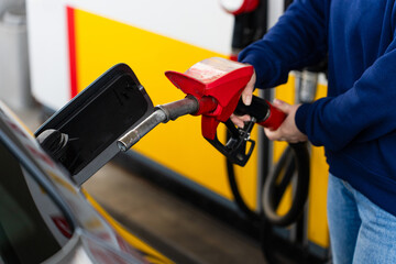 Car being refueled with fuel pump nozzle in tank. © Rabizo Anatolii