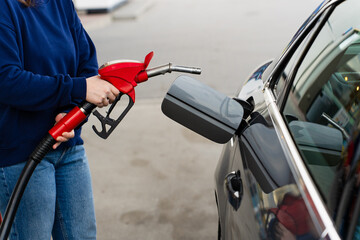 Close up of hand refilling vehicle with gasoline at gas station. © Rabizo Anatolii