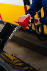 Vehicle refueling with fuel pump inserted in tank. © Rabizo Anatolii
