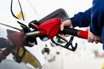 Car fuel tank being filled with gasoline at service station. © Rabizo Anatolii
