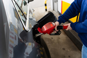 Fuel pump inserted into vehicle tank while refueling. © Rabizo Anatolii