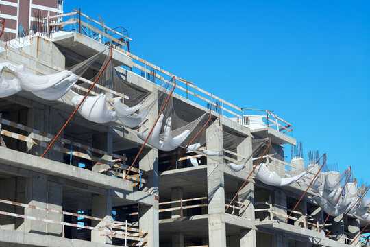 Construction of a multi-story building: Protective netting structure on a floor to guard against objects falling from above.