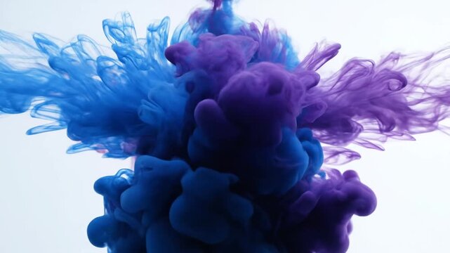 Dynamic blue and purple ink dissolving in clear water